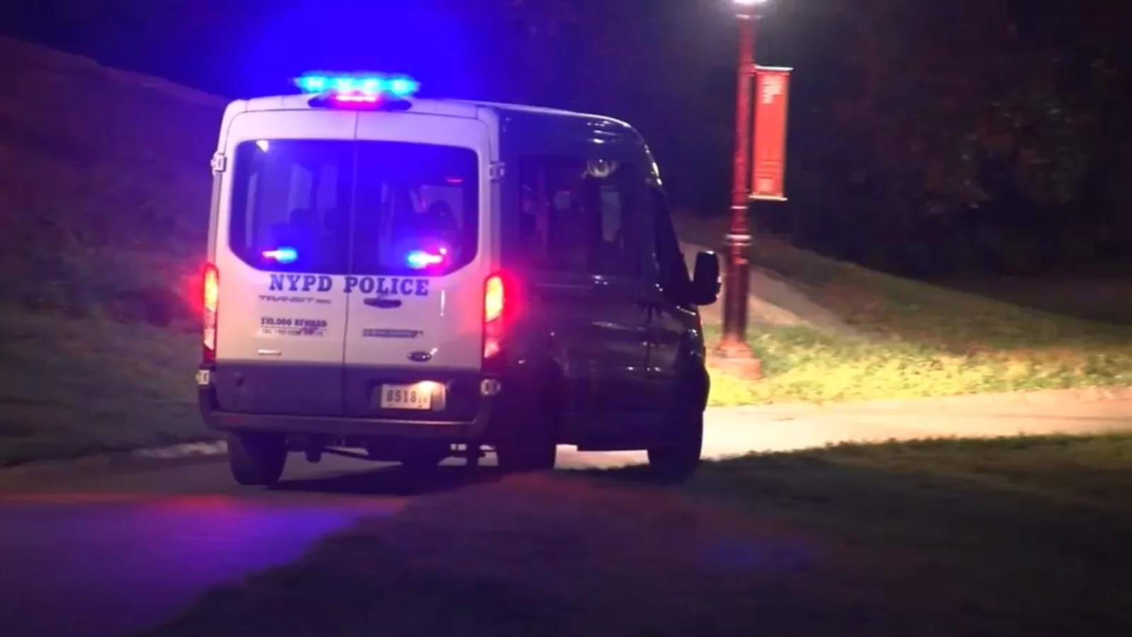 NYPD officers standing near Central Park after reports of four armed robberies