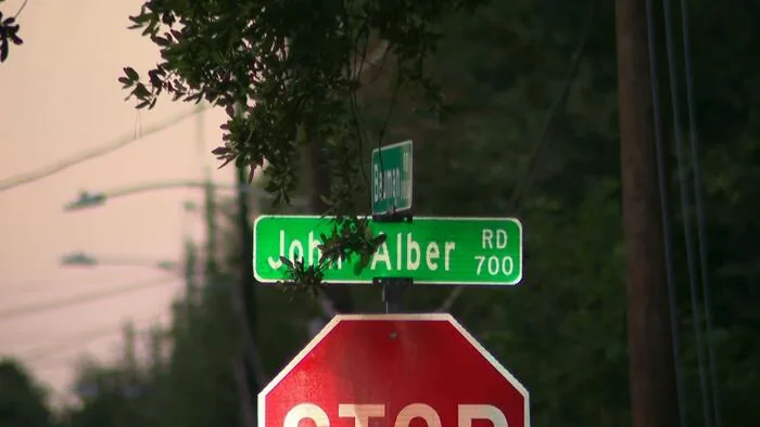 Police tape and emergency lights near a Harris County roadway investigation