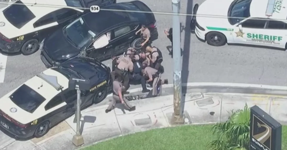 Police surround a disabled vehicle after a pursuit in northwest Miami-Dade